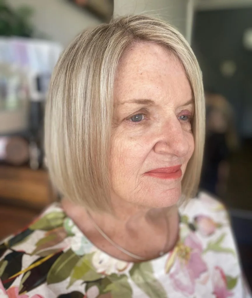 chin straight silver bob shown as a bob hairstyles for women over 60 idea, featuring silver color