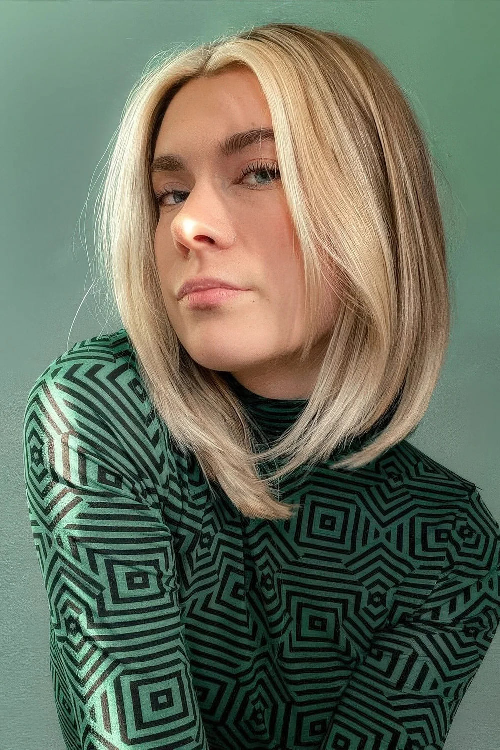 Fair long bob with a blonde layered money piece and middle part.
