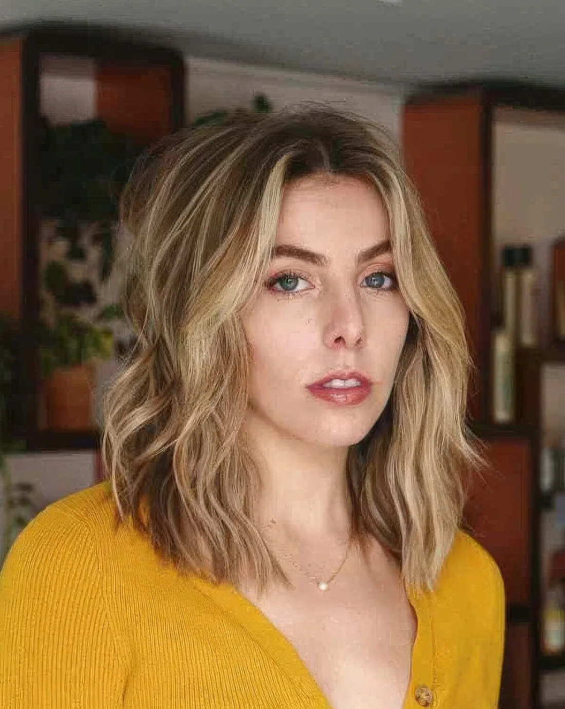 Layered brown lob with blonde highlights.