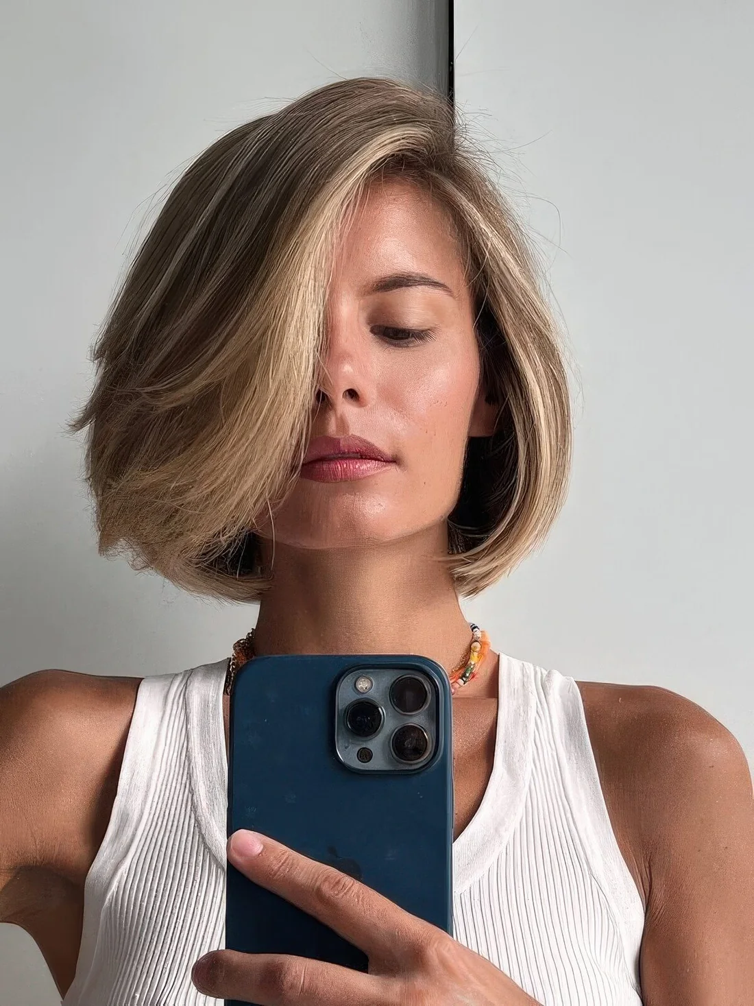 Light brow bob with blonde balayage and a blonde money piece.