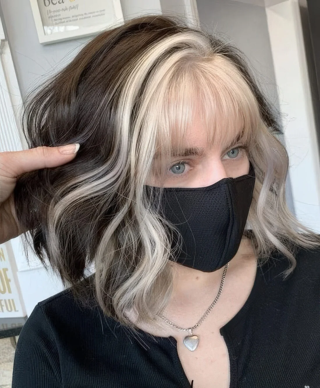 Dark brunette hair with icy blonde money piece and fringe.