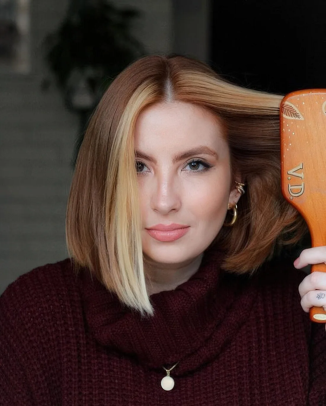 Red medium-length hair with blonde chunky money piece.