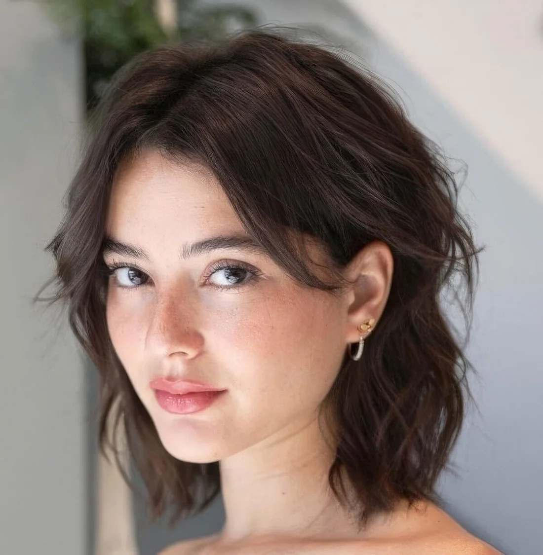Dark softly layered bob with center part.
