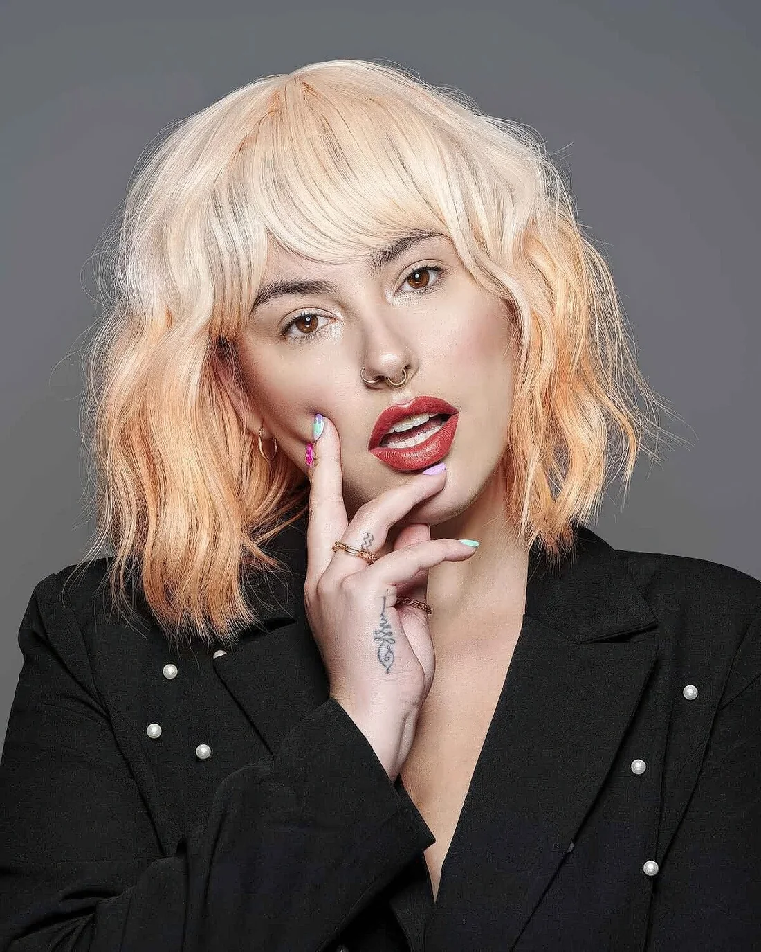 Ombre midi length bob with layers and side and wispy bangs.