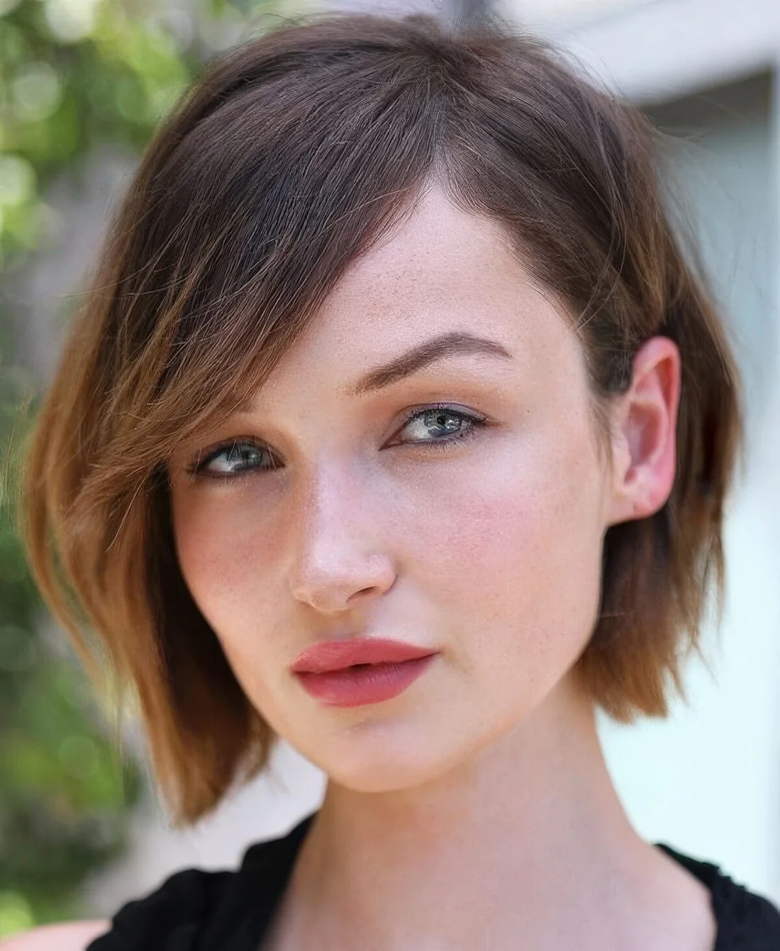 Chin-length brown bob with caramel ombre, side part and side bangs.