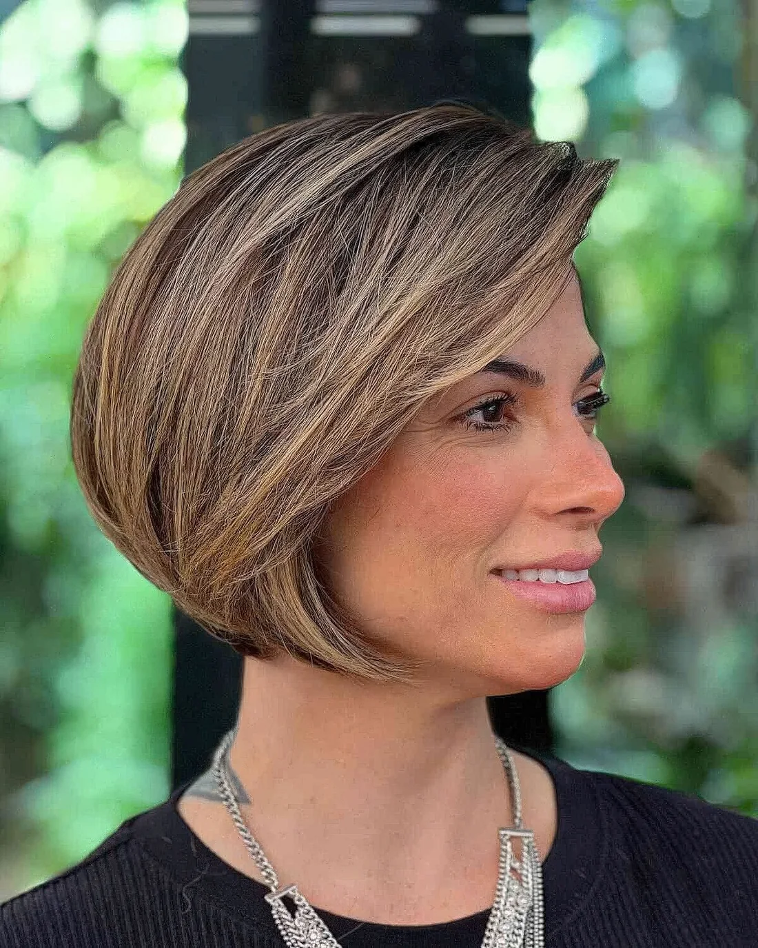 Graduated bob with long side bangs and a delicate balayage.