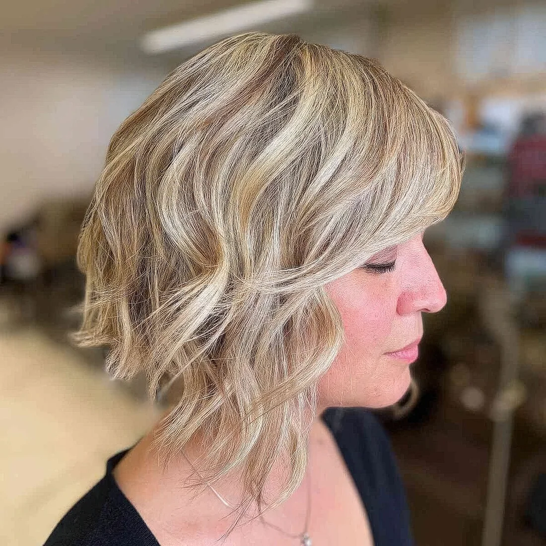 Textured bob with short side bangs for a sassy and fun look, and beachy balayage brings that relaxed vibe.