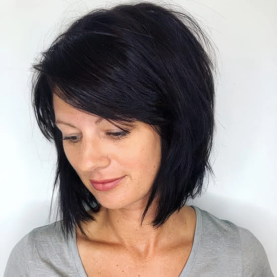 Textured stacked bob in black with side bangs.