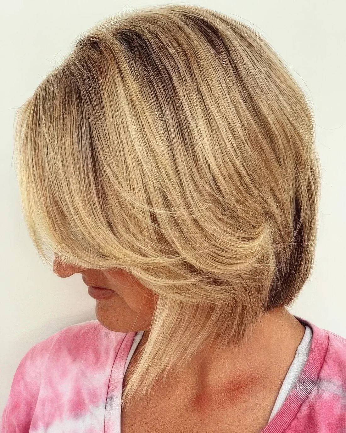 Line bob with side bangs done in a beautiful shade of blonde.