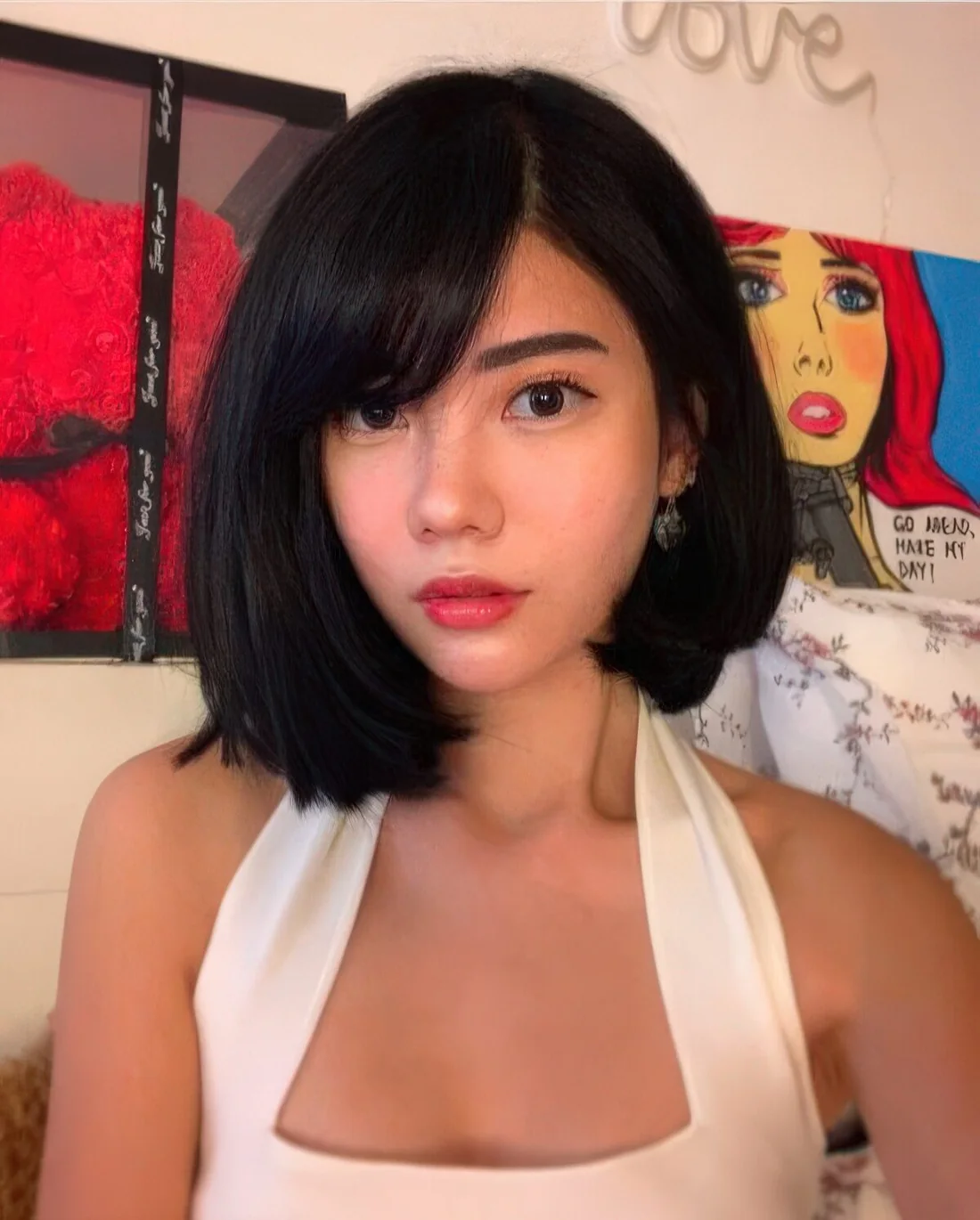 Asymmetrical black bob with side part and side bangs.