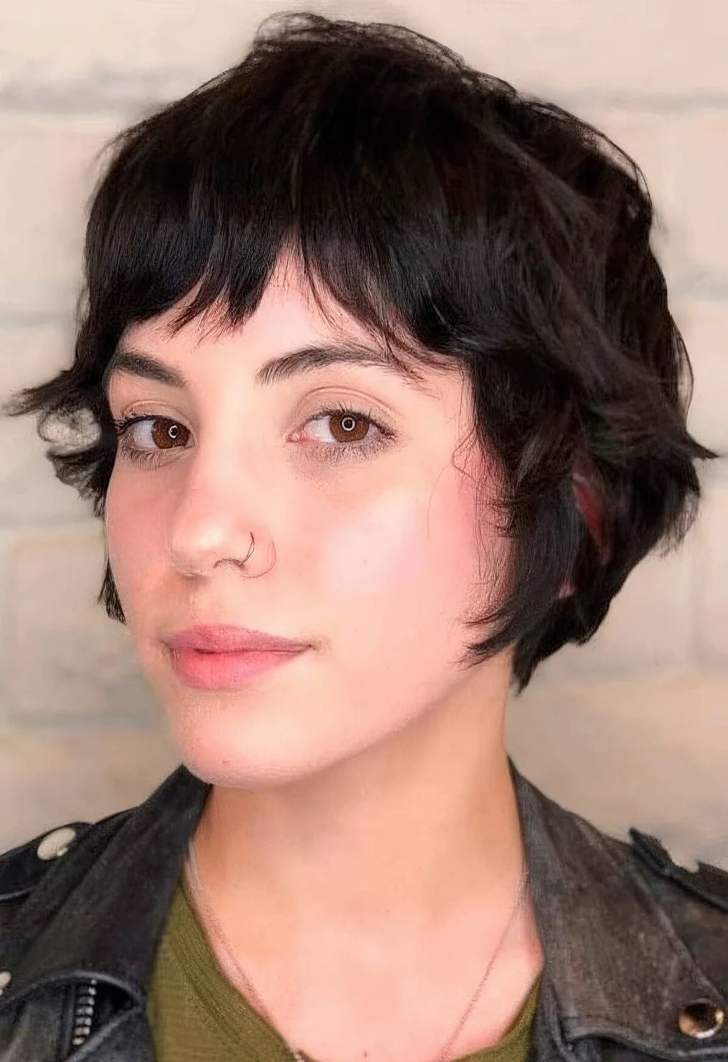 Black wavy bixie with bottleneck bangs.