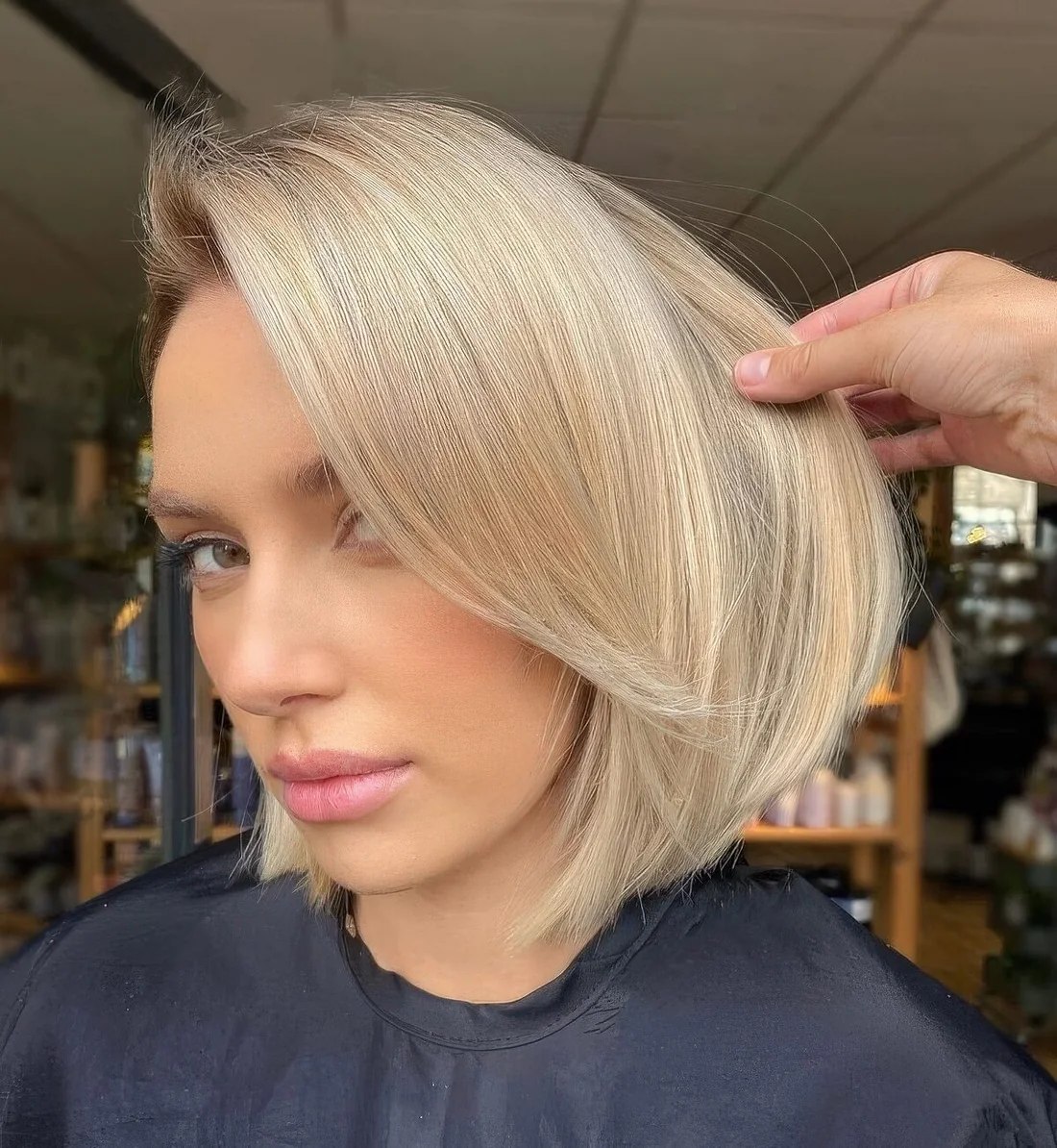 Blonde chin-length bob with curtain bangs.