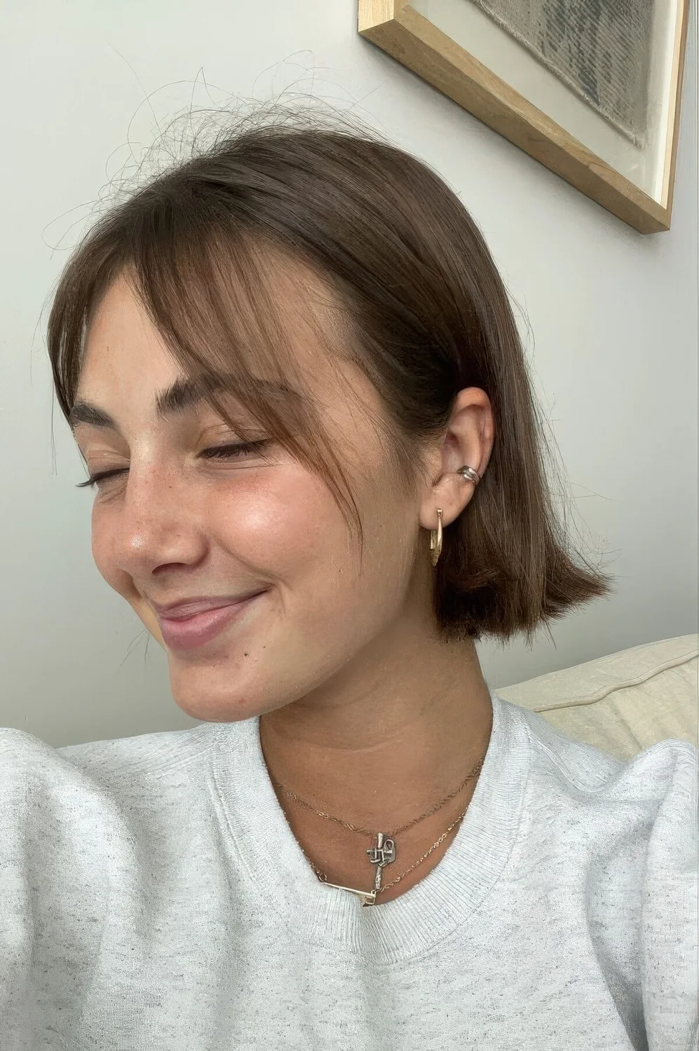 Brown chin-length bob with curtain bangs and center part.
