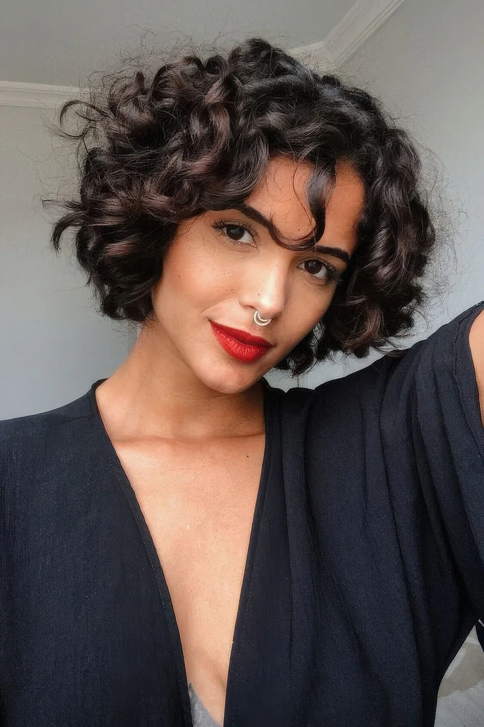 Dark brown and chestnut naturally curly chin-length bob.