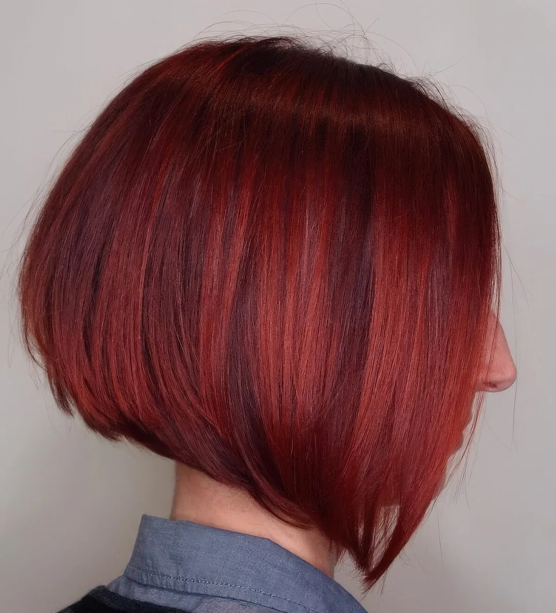 Photo showing hot red A line chin-length bob, with the hairstyle clearly visible.