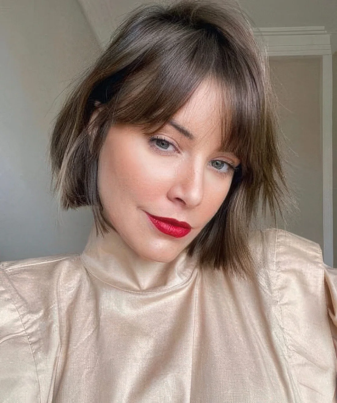 Mushroom brown chin-length bob with bottleneck bangs, texture and a bit of volume.