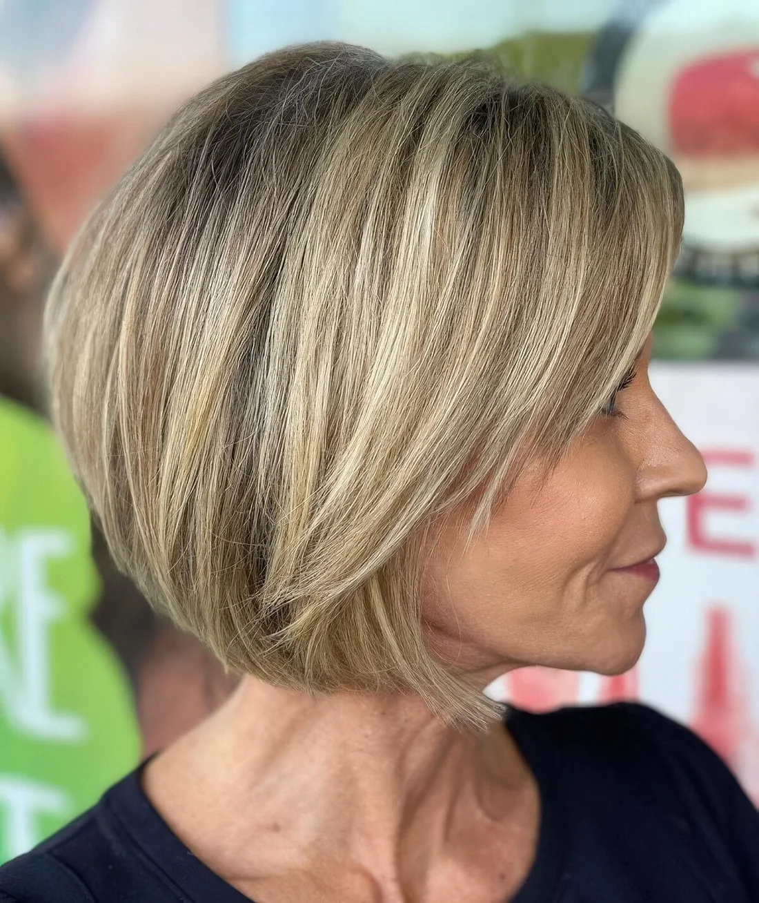 Blonde straight bob cut in layers to show off the beauty, with layered side bangs.