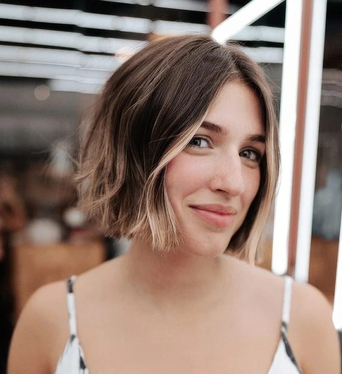 Brown bob with blonde highlights and blonde face-framing locks.