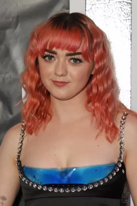 Channel the early '00s with a more modern take on straight bangs paired with a curly base.