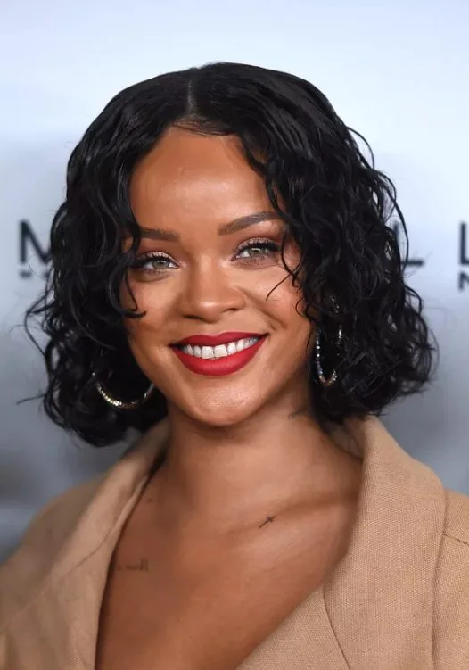 Rihanna's wet look bob features a few shorter pieces that hit around the apples of her cheeks, adding dimension to a mostly single length cut.