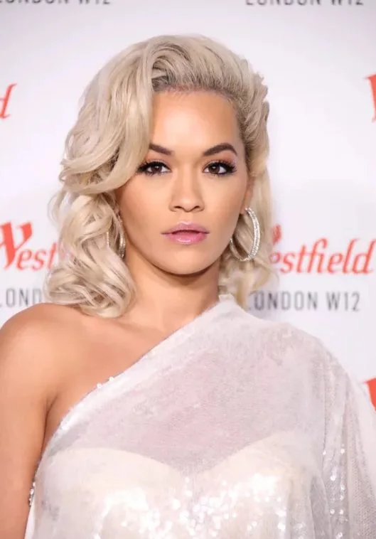 Rita Ora's lifted roots and dramatically curled side bangs have an old Hollywood starlet vibe.