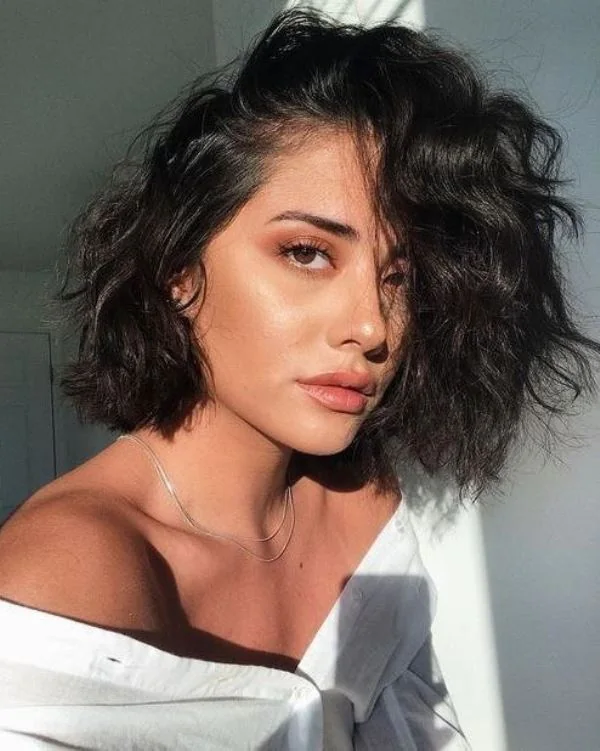 Photo showing black messy bob, with the hairstyle clearly visible.