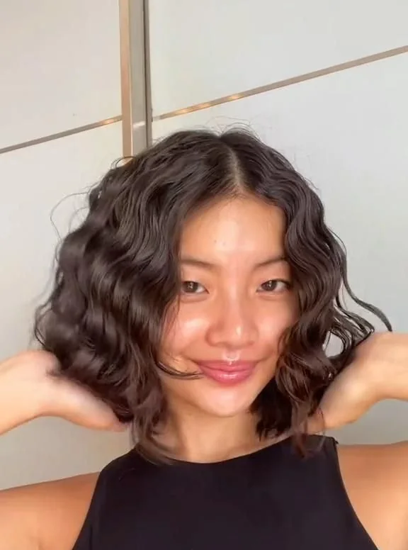 Photo showing dark brunette bob, with the hairstyle clearly visible.