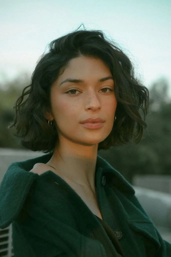 Photo showing dark wavy bob, with the hairstyle clearly visible.