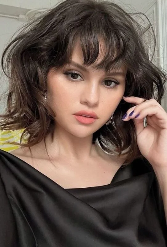 Photo showing messy brown bob, with the hairstyle clearly visible.