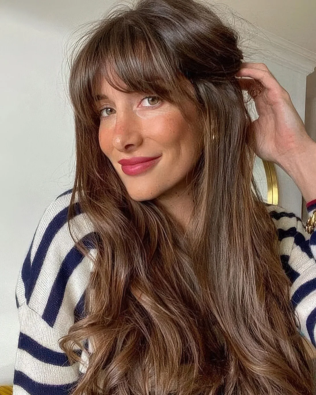 Dark brunette hair with bottleneck and curtain bangs and volume and a bit of waves.