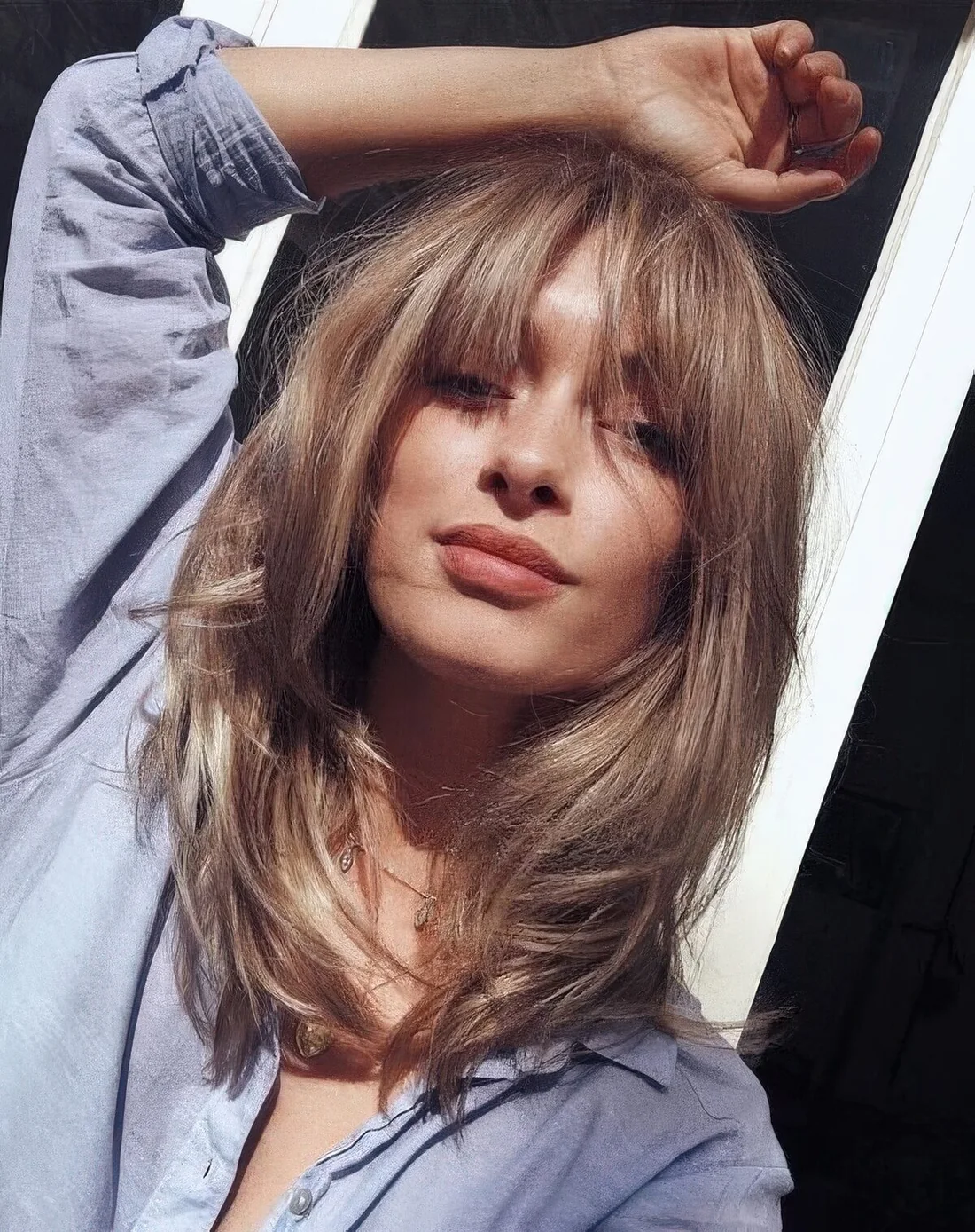 Bronde light bronde butterfly haircut with bottleneck bangs.