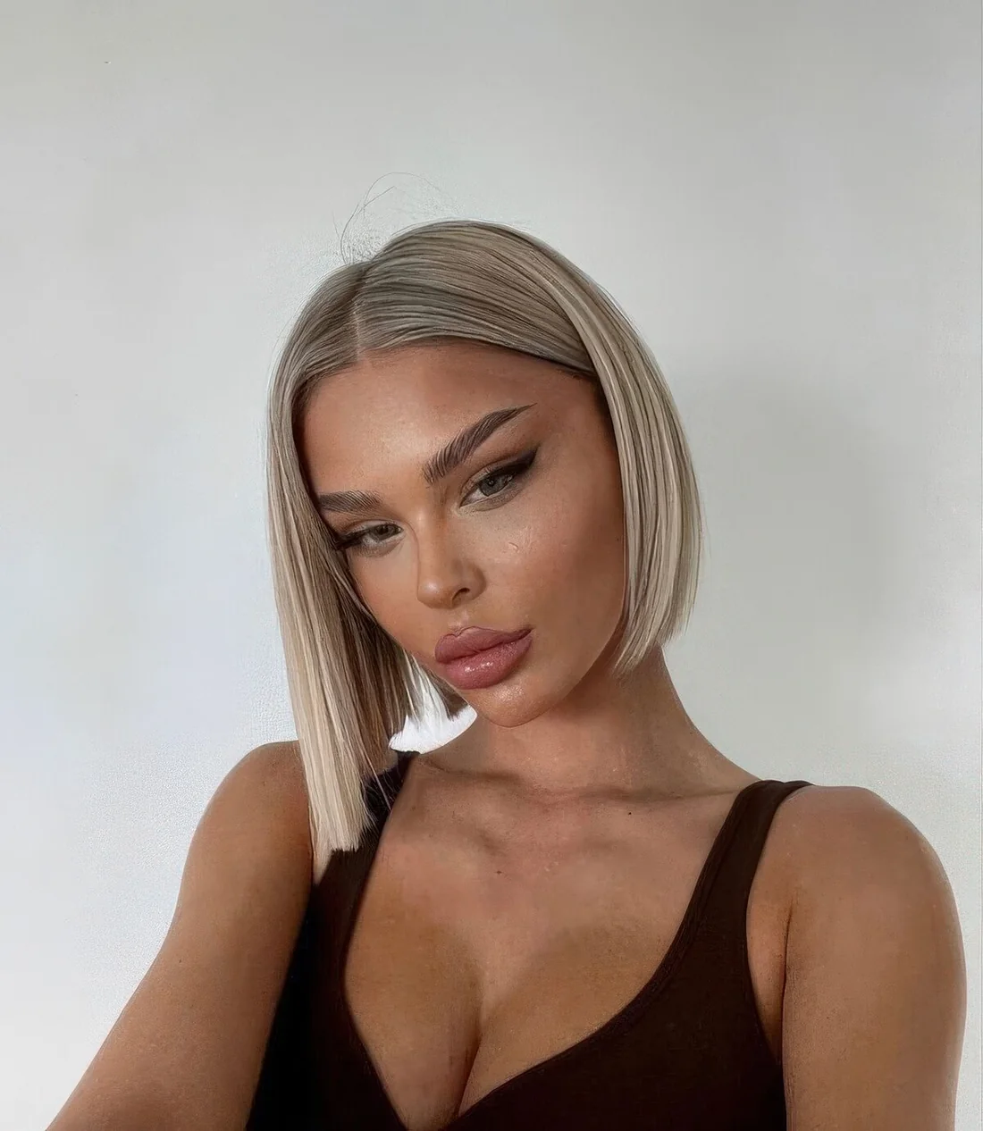 Photo showing blonde box bob with chin-length, with the hairstyle clearly visible.