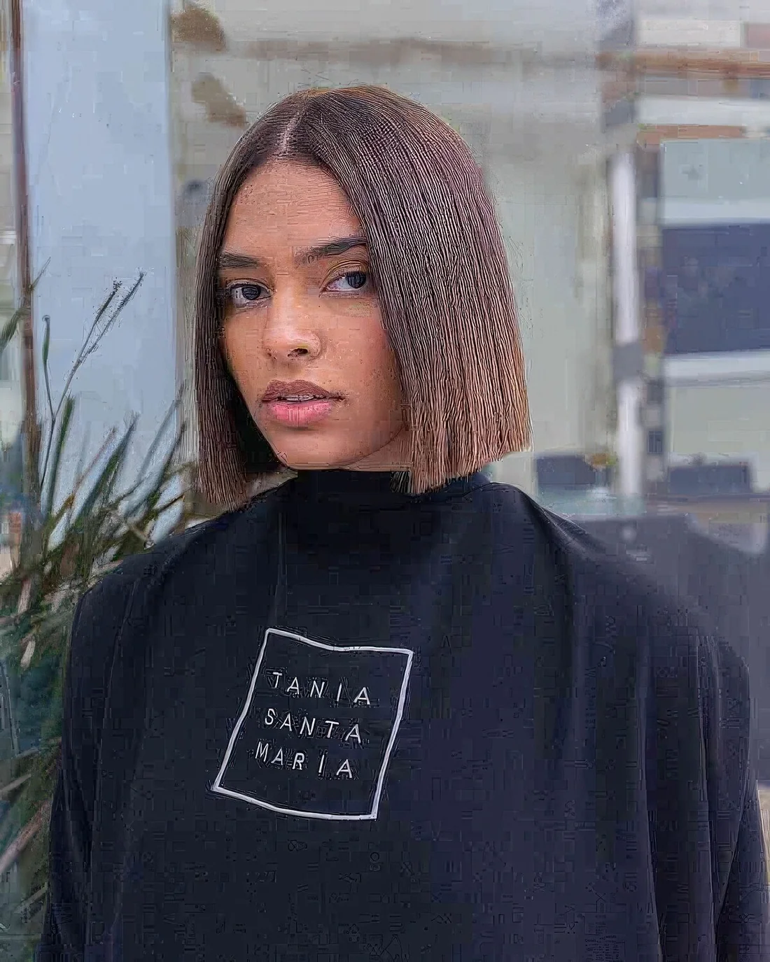 Sharp, sassy and catchy bob haircut with center part and straight hair.