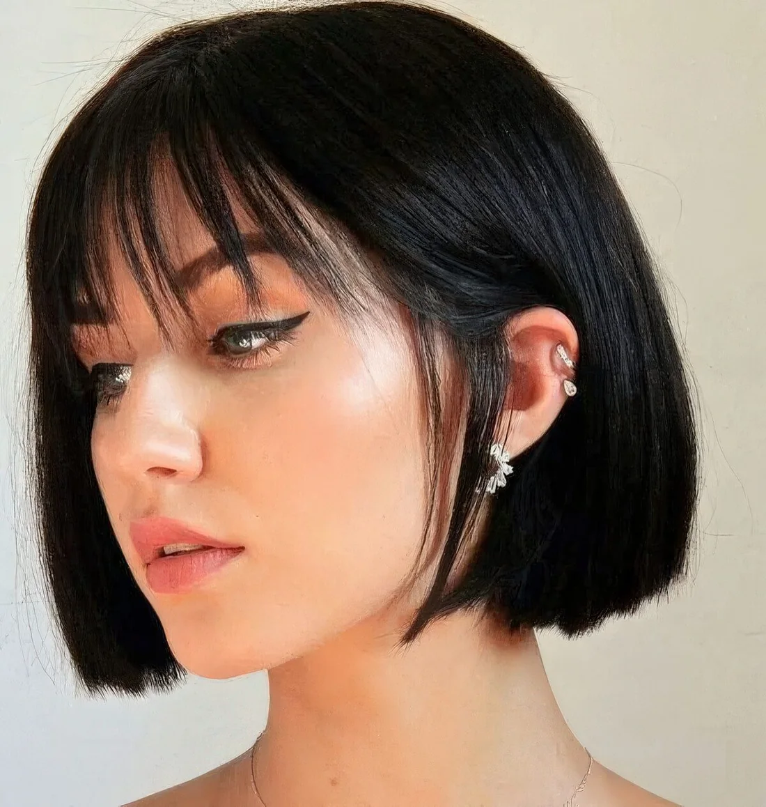 Sophisticated black box bob with wispy bangs.
