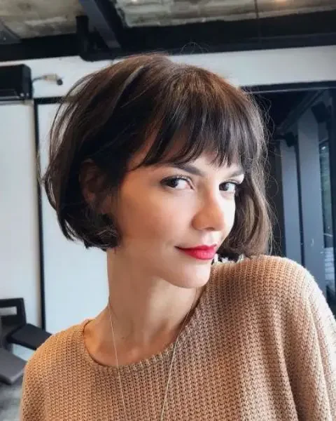 Brown boy bob with bangs and waves.