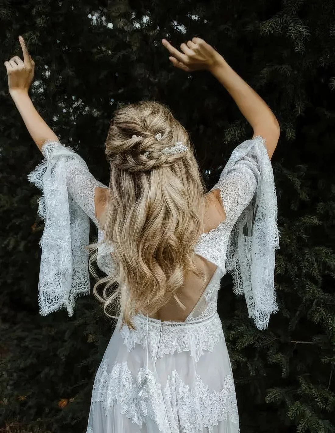 Boho half updo with twists and a braided halo, with waves down.