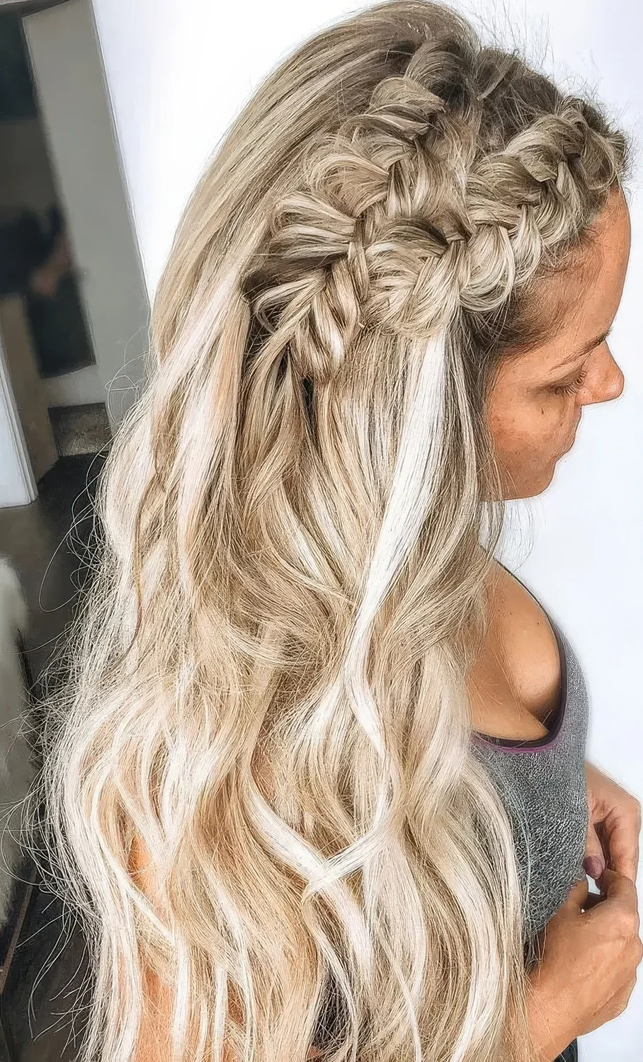 Boho wedding half updo with a double braid on top and waves down.