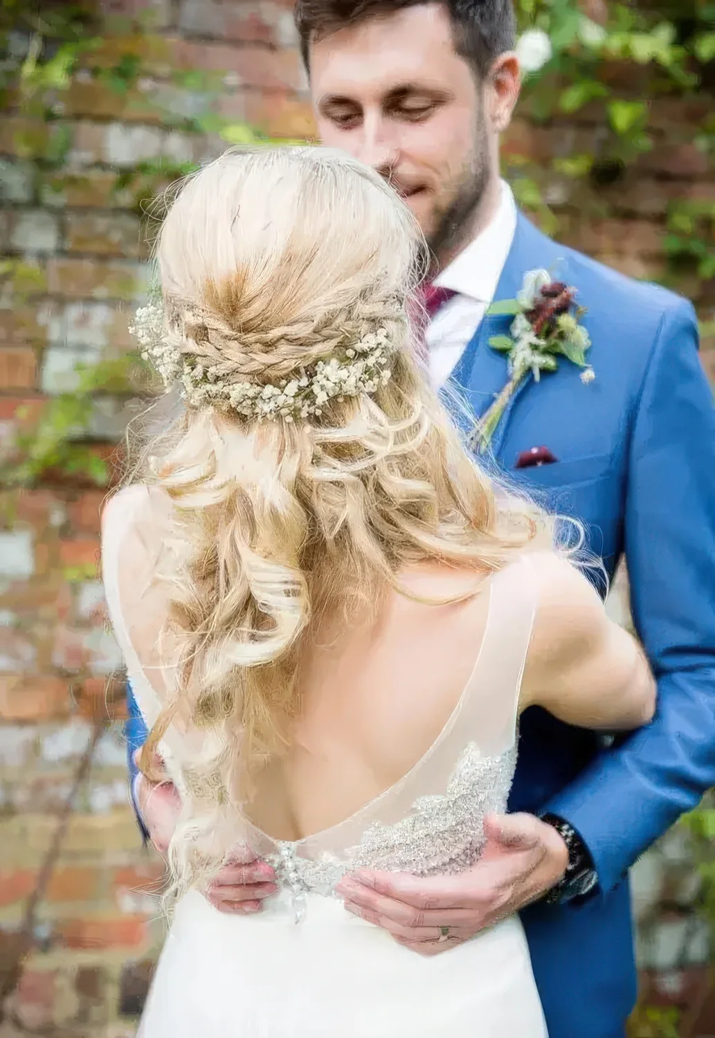 Braided half updo with a double halo and with baby's breath.