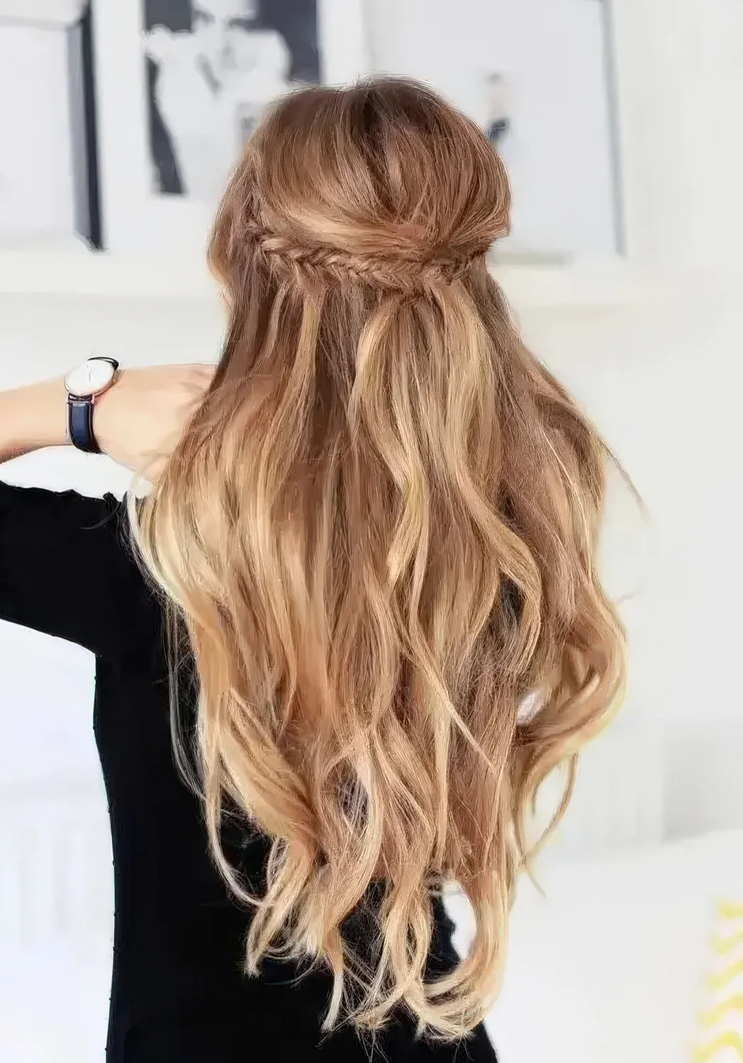 Braided half updo with light waves on long hair.