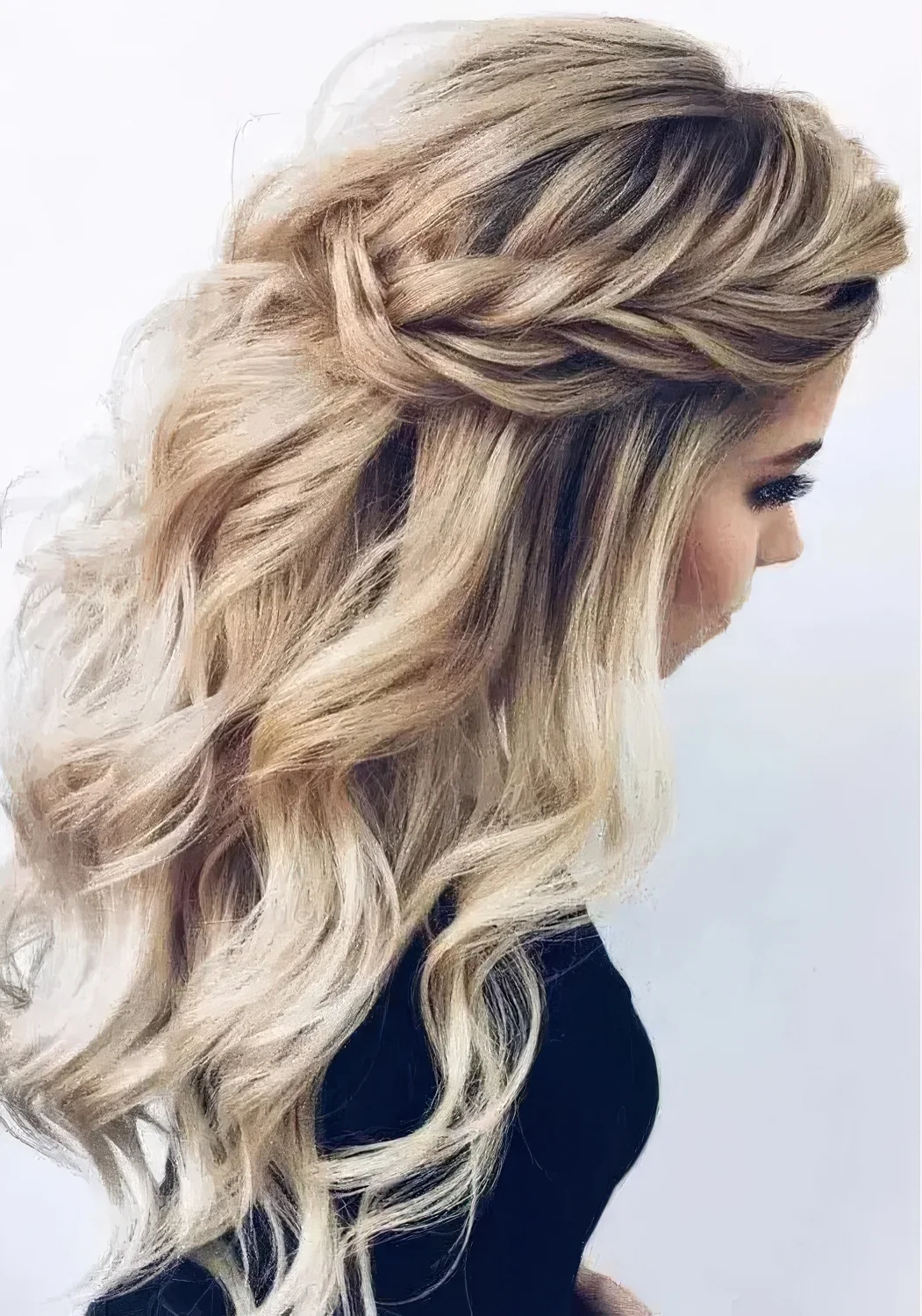Chic wedding half updo with braids on the front, waves down and a messy volume on top for a romantic bride.