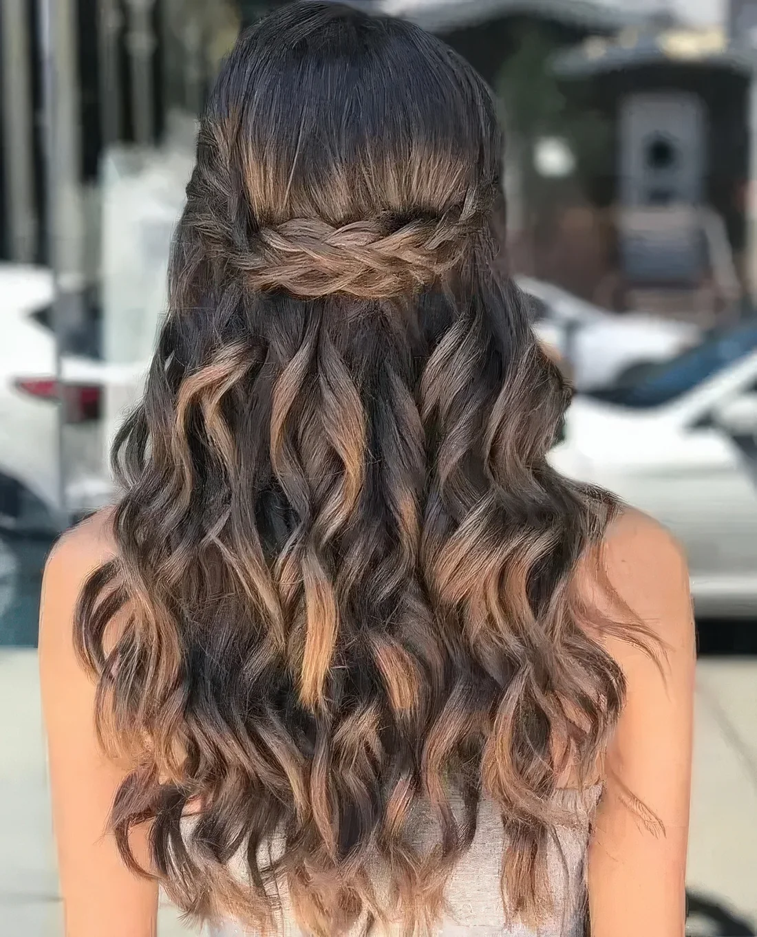 Wavy half updo with a Celtic braid element on top.