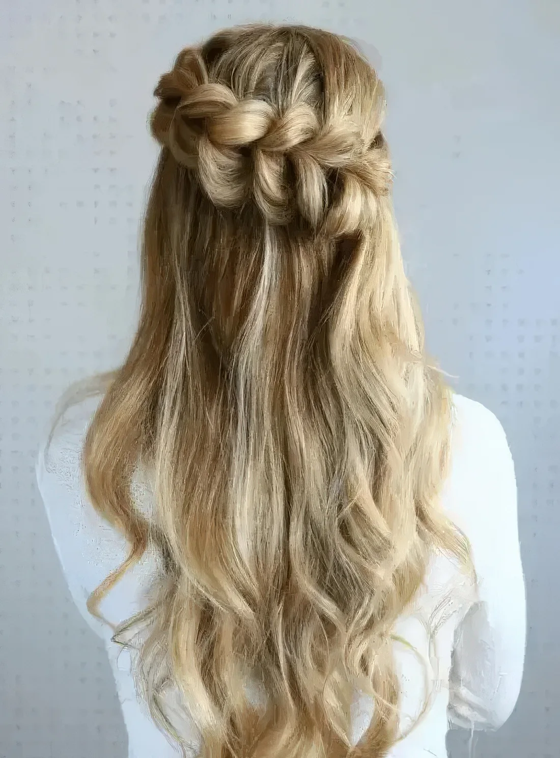 Half-up pull through braided hairstyle.