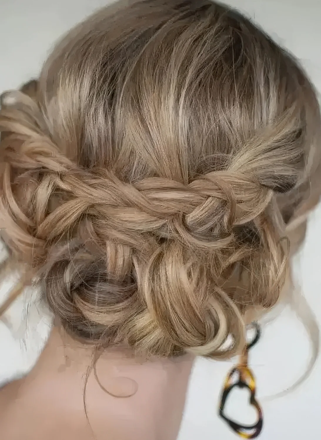 Boho updo with braids and twists and some waves down plus a bump on top.