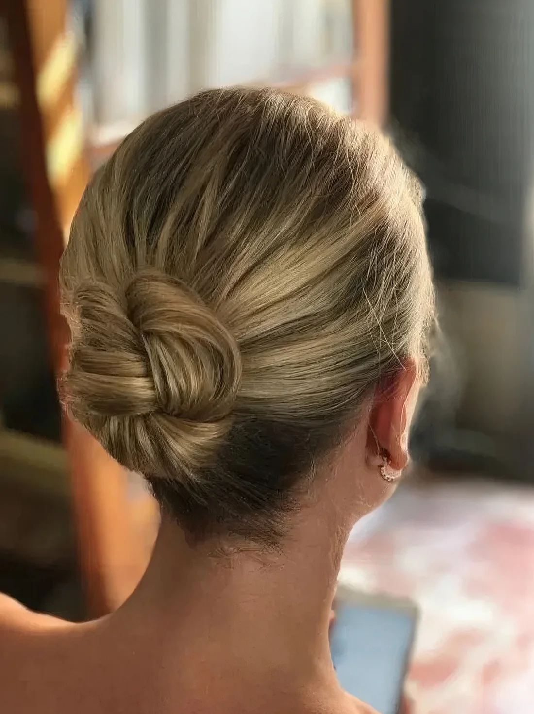 Photo showing low bun wedding hairstyle, with the hairstyle clearly visible.