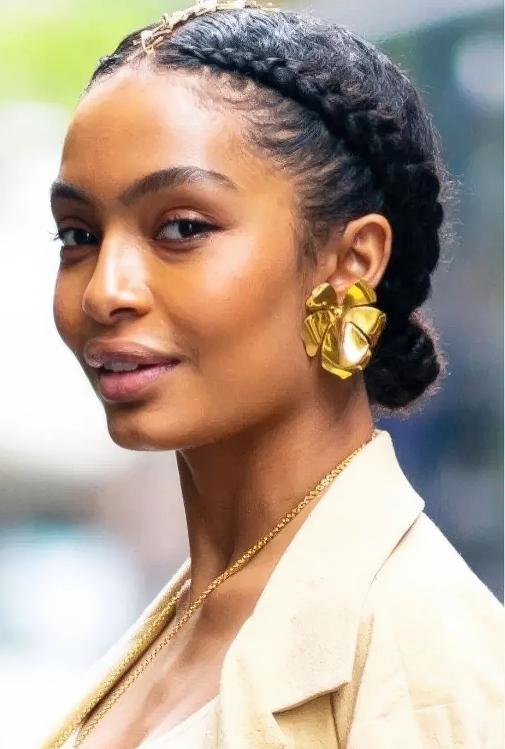 Braided low bun and braids on both sides of the head are a great and catchy special occasion or wedding updo.