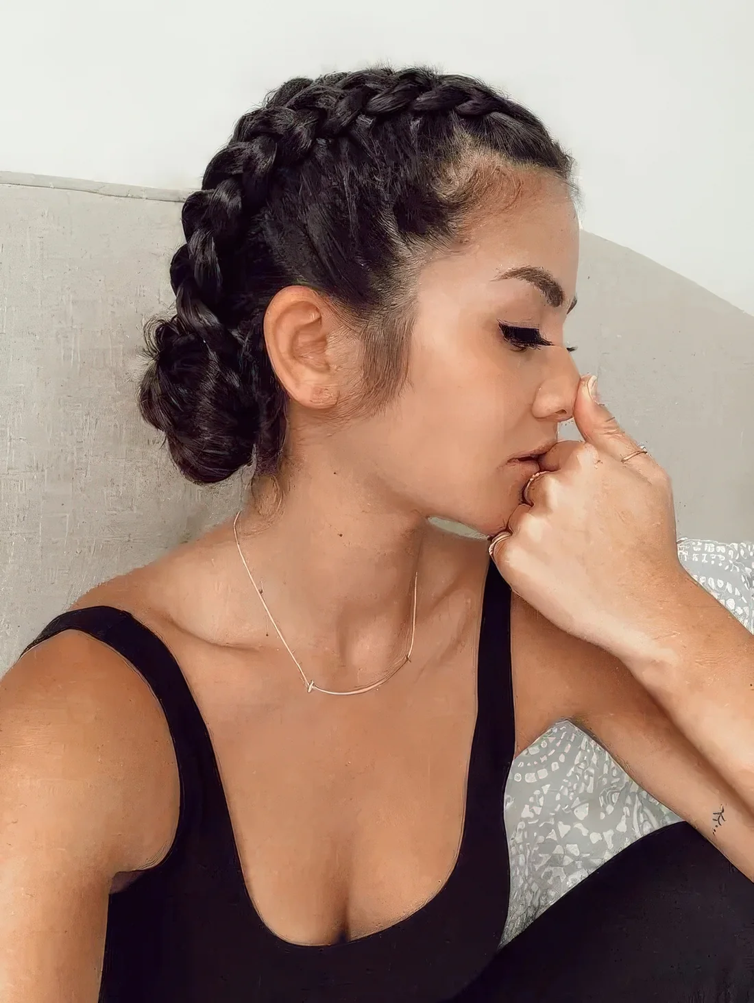 Photo showing braided low updo with two buns, with the hairstyle clearly visible.