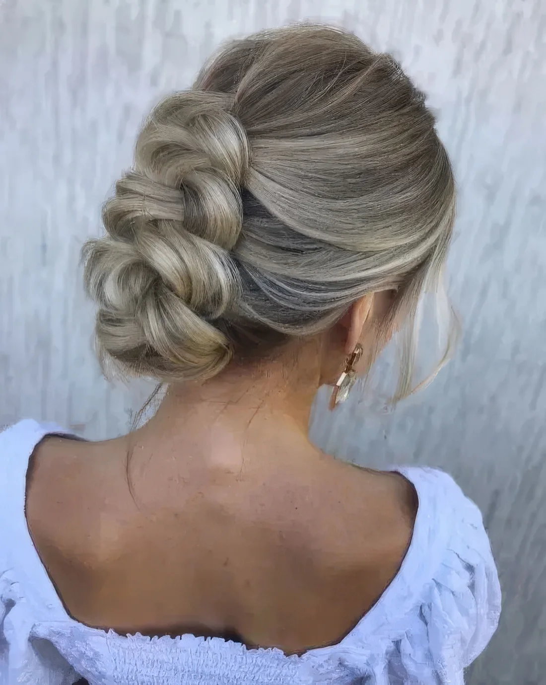 Photo showing braided updo with a bump on top, with the hairstyle clearly visible.