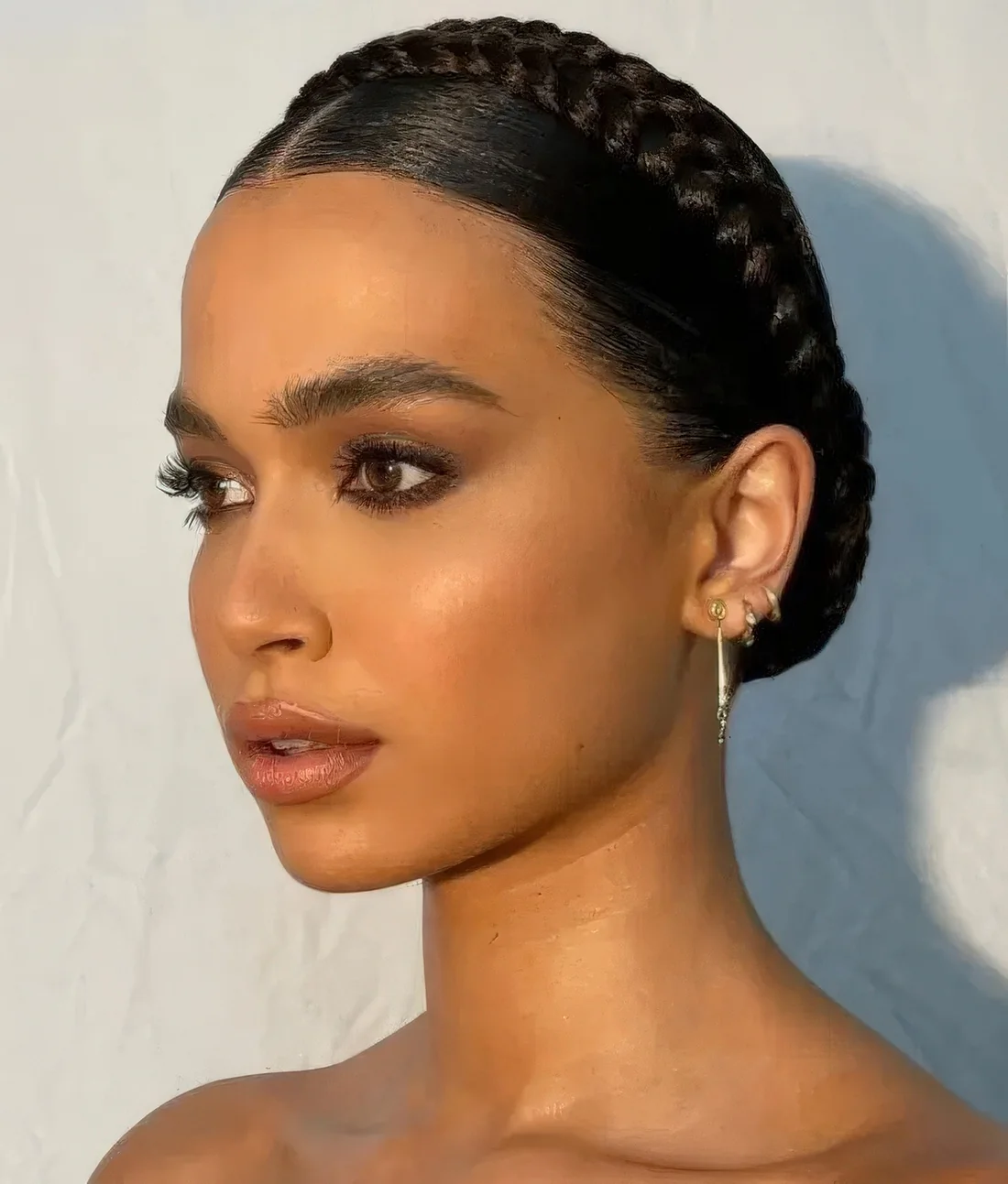 Updo with a small braided halo and a sleek top.