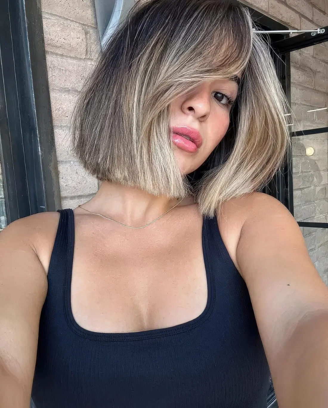 Bob with a slight blonde balayage and a lot of volume.