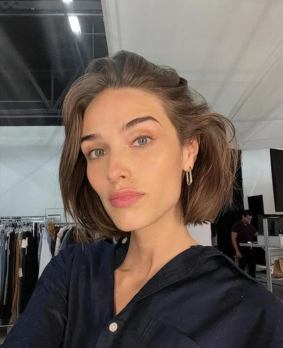 Chin-length bob with a lot of volume and styled back.